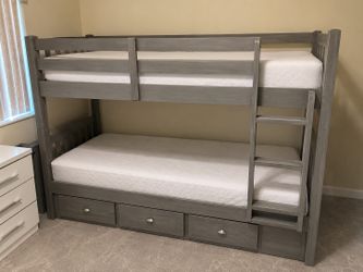 Grey wooden double bunk bed with two mattresses