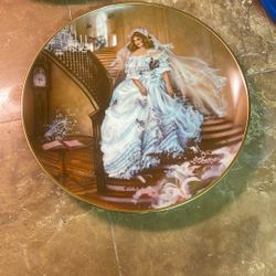 The item in the image is a vintage porcelain collector plate titled "Caroline" from the Portraits of American Brides series by artist Rob Sauber, prod