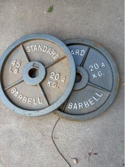 2- 45 pound Olympic standard barbell weights,