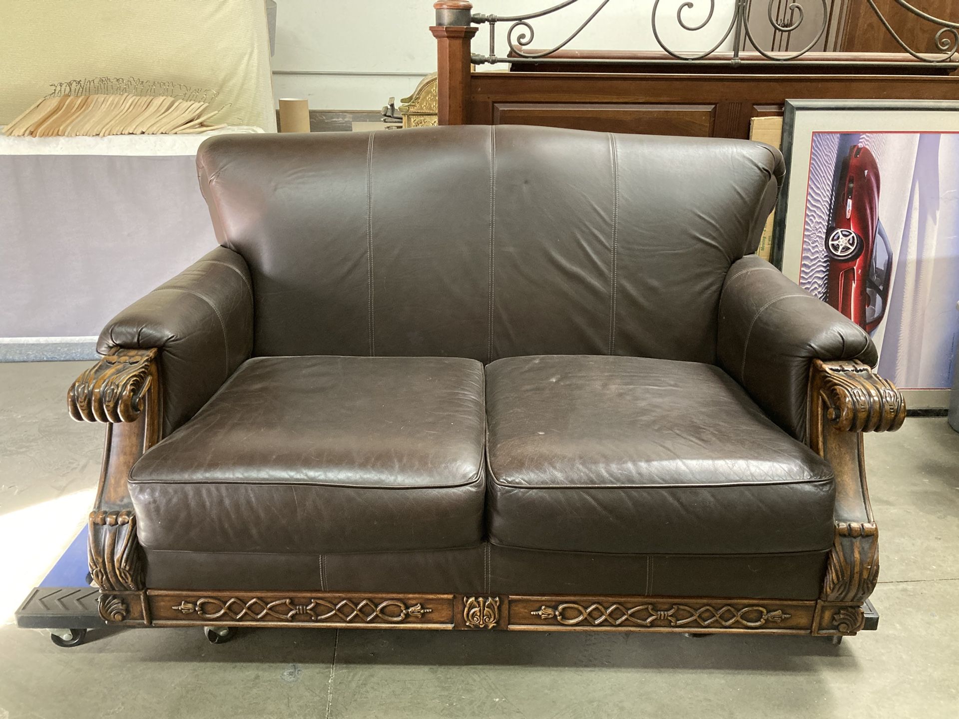 Brown leather Couch With Carved Wooden Feet And Arms