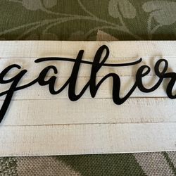 Wood and metal sign that says gather