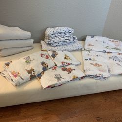 Naturepedic 2-stage Crib & Toddler Mattress, Naturepedic Mattress Covers, & Pottery Barn Sheet Sets (Paw Patrol & Finding Nemo)