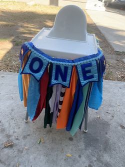 High chair and ONE banner, tie and 1 hat