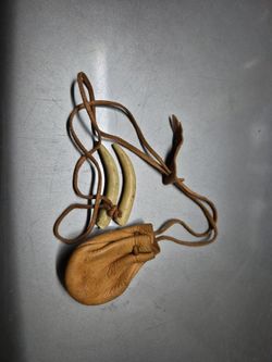 Two bore tusk and leather pouch