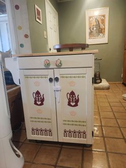 Kitchen island cart with natural wood top. Everything on it are decals that i made that can be taken off