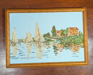 Framed needlepoint wall art piece depicting Claude Monet’s 1874 Impressionist painting, Regatta at Argenteuil