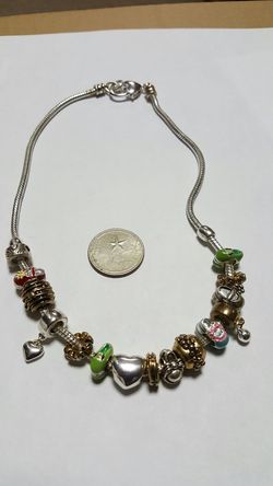 New silver plated necklace with charms.