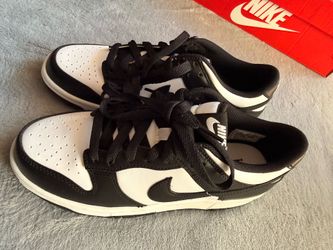 Nike Dunk Low sneakers feature a classic two-tone black and white leather construction the "Panda" colorway.