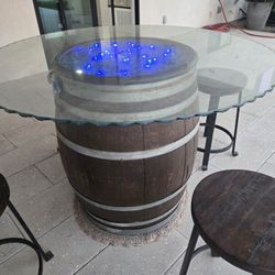 Gorgeous whiskey barrel table with fire glass and led lights