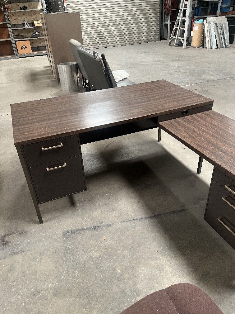 desk, tables and file cabinets.