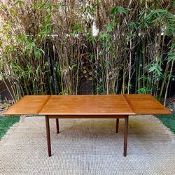 For sale is a stunning Mid-Century Danish Teak Extension Dining Table, made in Denmark circa 1960s.  The relatively compact 53" long table effortlessl