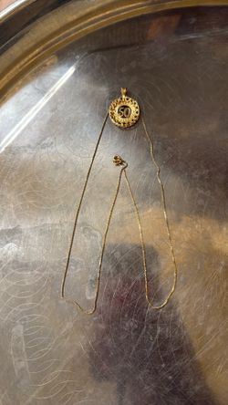 Price is firm 14 K solid GOLD chain with the pendant tell the weight is 7.47 g