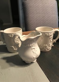 Decorative white stem coffee cups and milk pourer