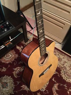 PRS acoustic guitar with hard shell case.