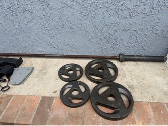 Olympic weights 25lb set and 10 lb set with a barbell