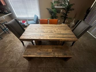 West Elm reclaimed wood dining table with bench and chairs.