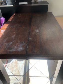 wooden table with leather chairs