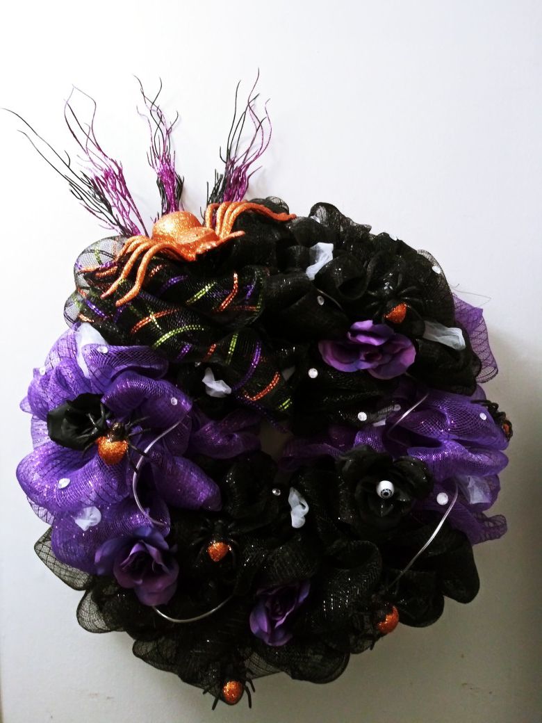 HALLOWEEN wreath with purple lights,orange spiders, purple and black flowers, gems and eye balls.
