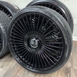 New 24 inch gloss black wheels with floating Range Rover caps wrapped in Lexani 295/30r24 tires
