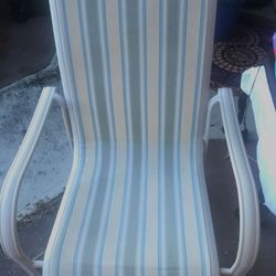 2 chairs one striped one green Stackable