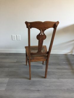 Wooden chair with cane seat.