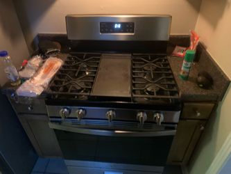 Stainless steel fridge and stove combo.