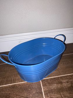 Blue oval metal or plastic tub with side handles