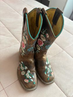 Brown cowgirl boots, black boots crocs and white Air Force