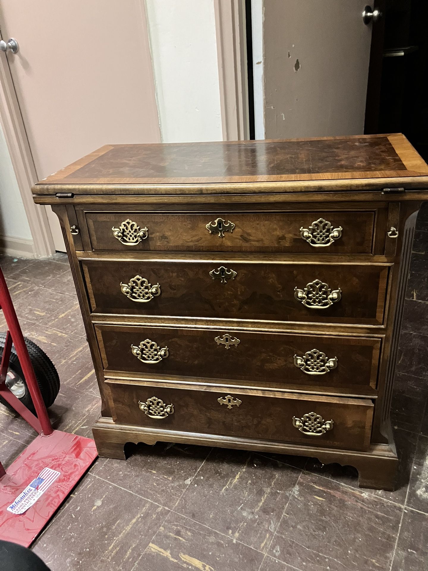 A Vintage Dresser With A Foldable Table Top