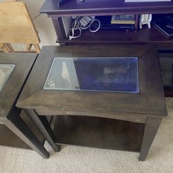 Two dark wood end table with a glass insert and a bottom shelf