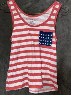 Fifth Sun red and white striped tank top featuring a pocket with stars.Brand: Fifth Sun.Material: 65% Polyester, 35% Rayon.Size: Extra Small.