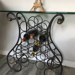 Beautiful wrought iron wine display and storage with glass top
