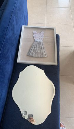 Wall decor mirror and framed dress.