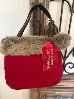 red quilted Bath & Body Works tote bag featuring a fluffy brown faux fur trim and a "pampered princess" tag