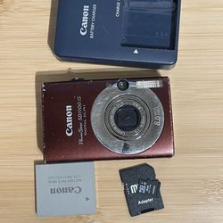 Canon Powershot SD1100 Brown Digital Camera - Tested Works  Includes battery, charger, memory card. Flash zoom video photo all working. has heavy cosm