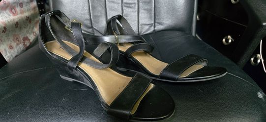 black leather wedge sandals with a gold buckle ankle strap
