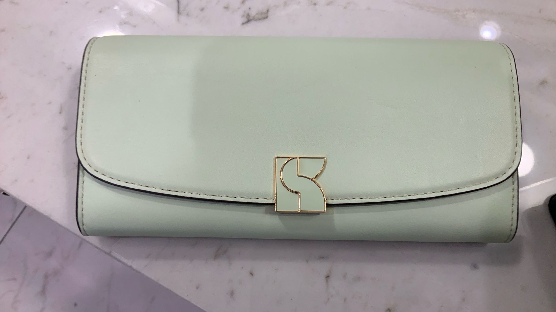 Kate Spade A beautiful ombré sunset set against a Saffiano leather backdrop makes this zip-around wallet one you'll want to show off. Top zip-aro