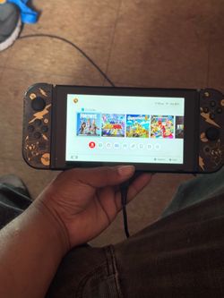 Nintendo switch with custom black/gold controls Pokémon