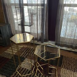 two gold side/display tables 