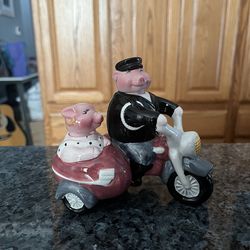 Ceramic Pigs On A Motorcycle with Sidecar Pair of Salt And Pepper Shakers. The Heads are the shakers, Removeable Heads. Brand new never used. Has b