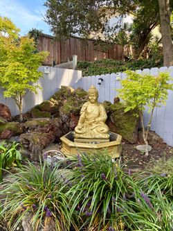 Meditating Buddha waterfall and statues