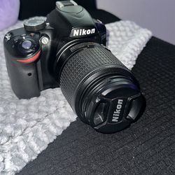 Nikon D3200 digital SLR camera 55-200mm lens, battery bag, three batteries, and charger