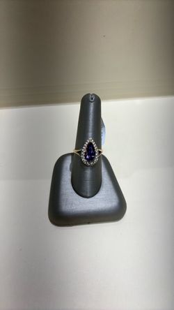 Gold Ring with Pear-Cut Purple Stone and Halo
