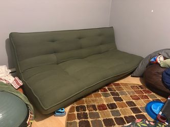 Futon sleeper sofa, full-size when flat, by Urban Outfitters, green
