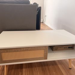 White coffee table with sliding door.