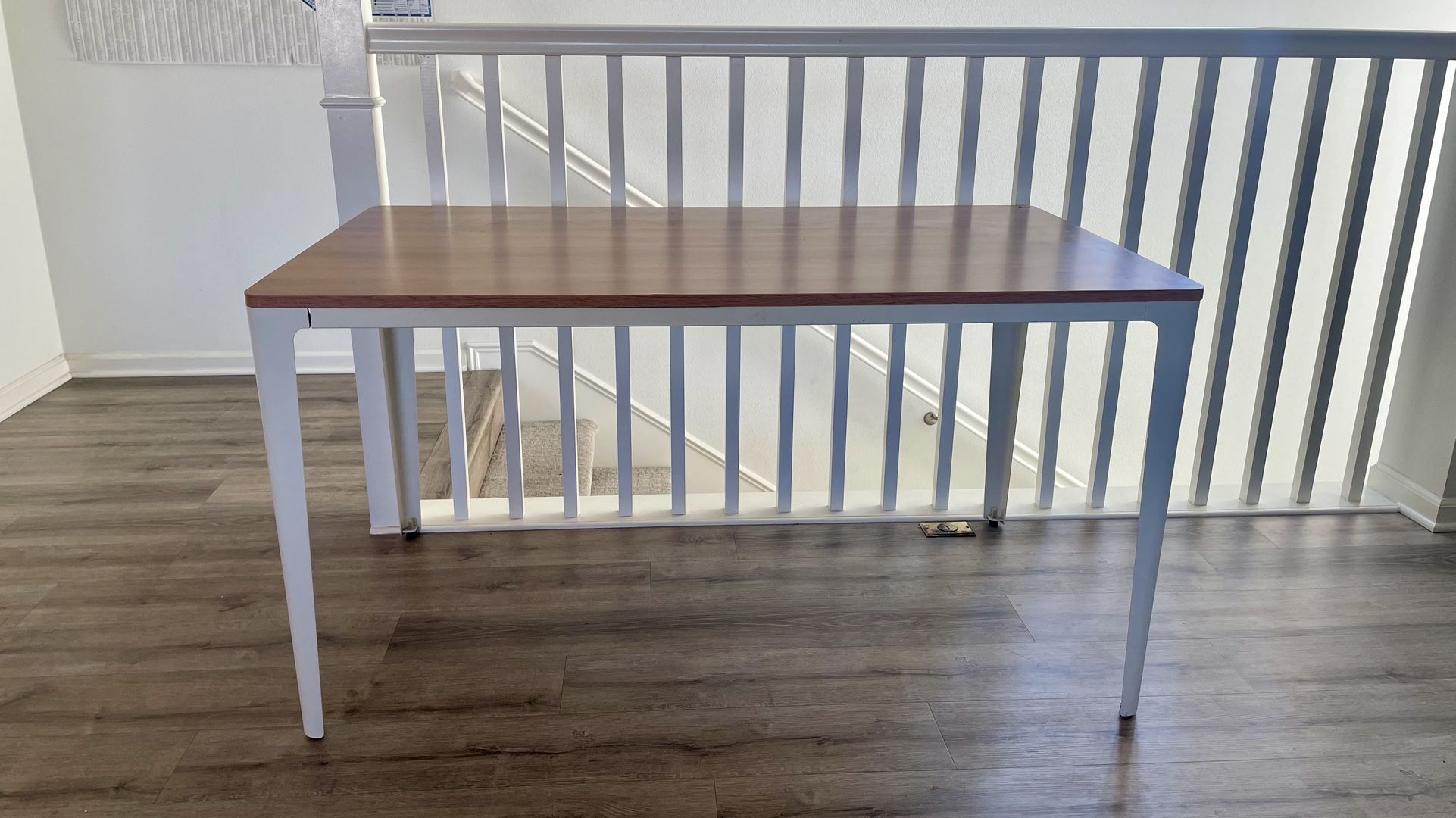 Wooden table top. Steel leg table.