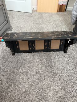 2 wooden hanging shelves with pictures frames
