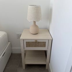 Light wood nightstand with cane drawer