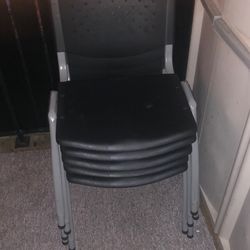 5 black plastic chairs with metal legs