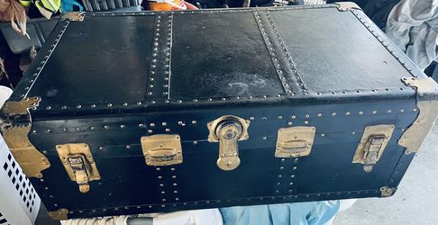 Vintage steamer trunk used on railway. Black with gold